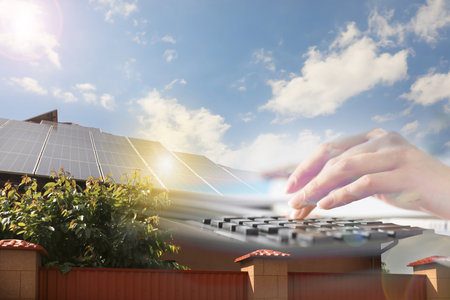 Double exposure panels of house with installed solar and woman using calculator. Renewable energy...