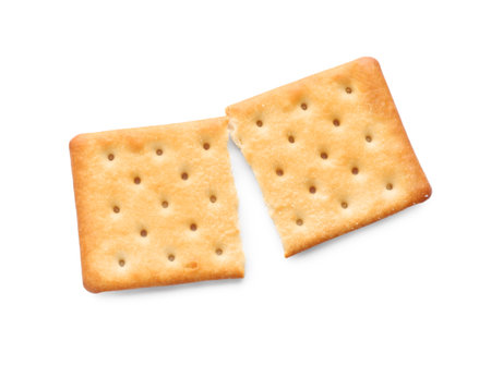 Broken delicious crispy cracker isolated on white, top view
