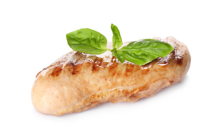 Tasty grilled chicken fillet and green basil isolated on whiteの写真素材