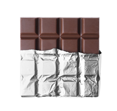 Delicious milk chocolate bar wrapped in foil isolated on whiteの写真素材