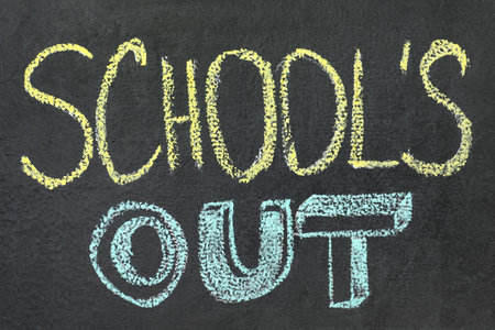 Text School's Out written on black chalkboard. summer holidays