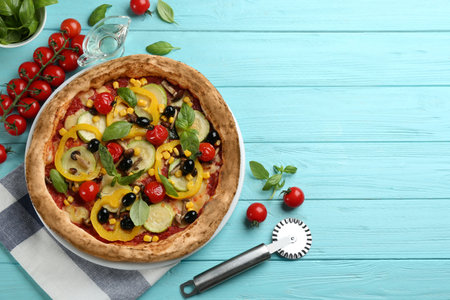 Flat lay composition with vegetable pizza on light blue wooden table. Space for textの写真素材