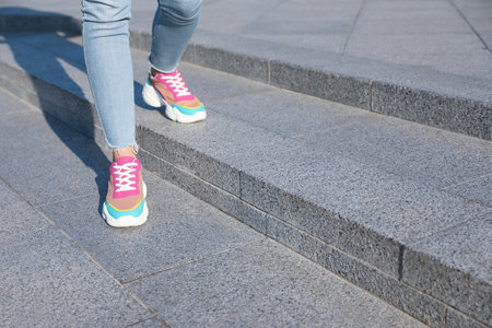 Woman on stairs outdoors, closeup with space for text. Choosing way concept.の写真素材