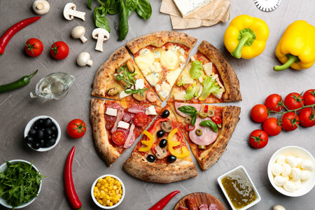 Flat lay composition with slices of different delicious pizzas on gray tableの写真素材