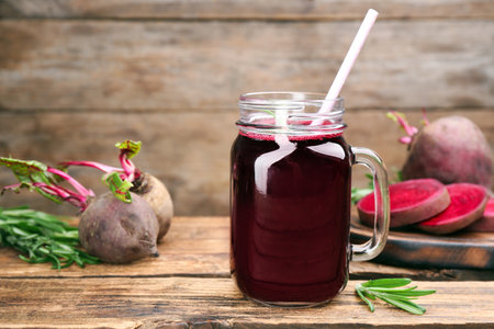 Freshly made beet juice in mason jar on wooden tableの写真素材