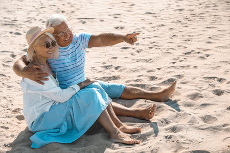 Mature couple spending time together on sea beachの写真素材