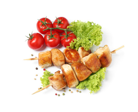 Delicious chicken shish kebabs and vegetables on white background, top viewの写真素材