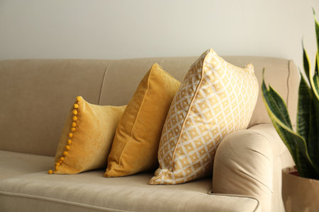 Three pillows on sofa near wall in room. interior design