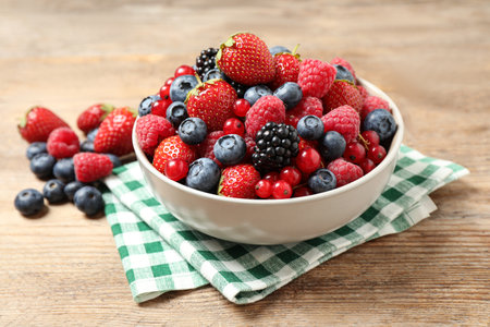 Mix of ripe berries on wooden tableの写真素材