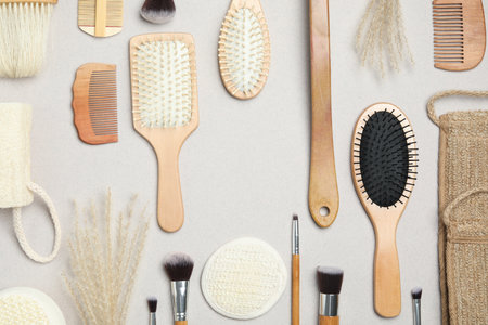 Flat lay composition with modern hair combs and brushes on light backgroundの写真素材
