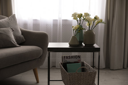 Beautiful spring freesia flowers on table in room
