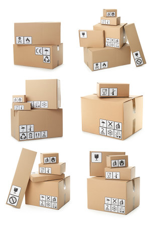Set of cardboard boxes with packaging symbols on white backgroundの写真素材