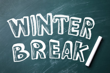 Text Winter Break and piece of chalk on school greenboard, top viewの写真素材