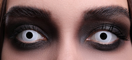 Mysterious witch with spooky eyes, closeup. halloween partyの写真素材