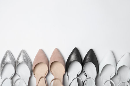 Many stylish female shoes on white background, top viewの写真素材