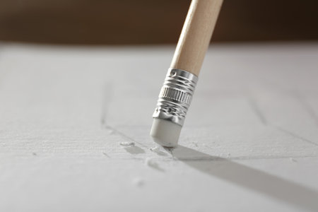 Correcting picture on paper with pencil eraser, closeup