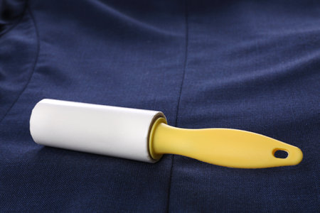 New lint roller with yellow handle on blue jacket