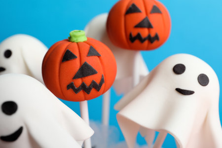 Delicious Halloween themed cake pops on light blue background, closeupの写真素材