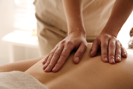 Young woman receiving back massage in spa salon, closeupの写真素材