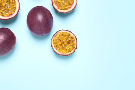 Fresh ripe passion fruits (maracuyas) on light background, flat lay. Space for textの写真素材