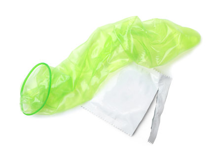 Unrolled green condom and package on white background, top view. safe sexの写真素材