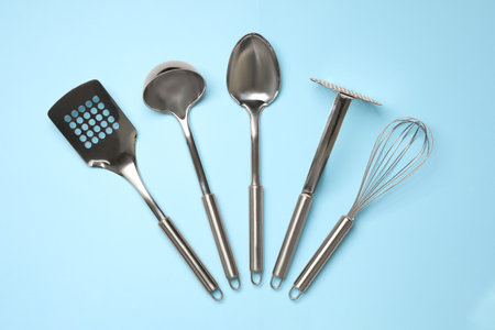 Set of modern cooking utensils on light blue background, flat layの写真素材