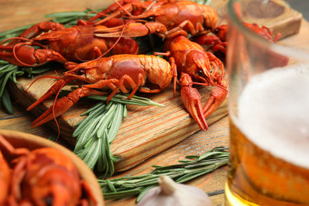 Delicious red boiled crayfishes on wooden board, closeupの写真素材