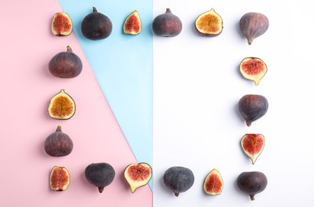 Delicious ripe figs on color background, flat lay. Space for textの写真素材