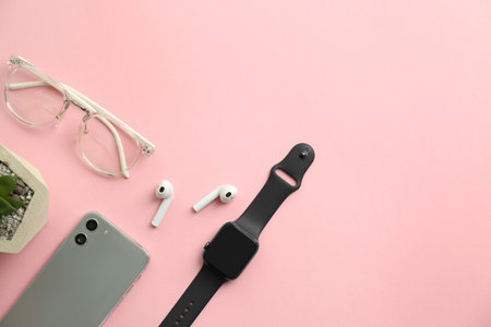 Flat lay composition with stylish smart watch on pink background. Space for textの写真素材
