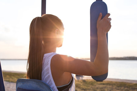 Young woman training near the river in the morningの写真素材