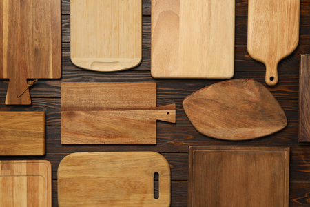 Set of wooden boards on brown table, flat lay. Cooking utensilsの写真素材
