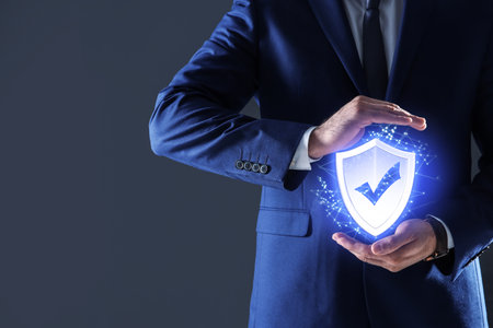 Cyber insurance concept. Man demonstrating shield illustration as symbol of protection, closeupの写真素材
