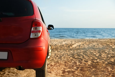 Modern red car on sandy beach, space for text. summer tripの写真素材