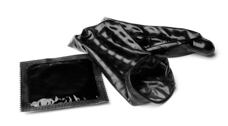 Unrolled black condom and package on white background. safe sexの写真素材