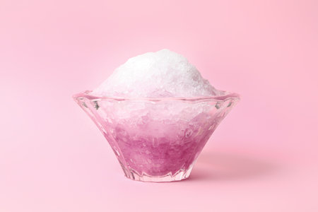 Shaving ice in glass dessert bowl on pink background, closeupの写真素材
