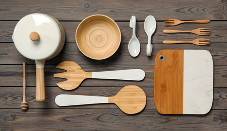 Set of modern cooking utensils on wooden table, flat lay