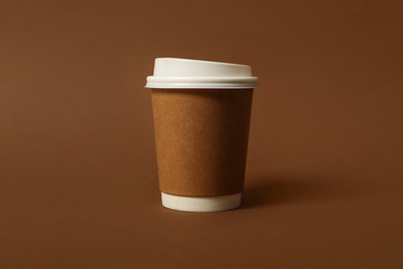 Takeaway paper coffee cup on brown background, closeupの写真素材