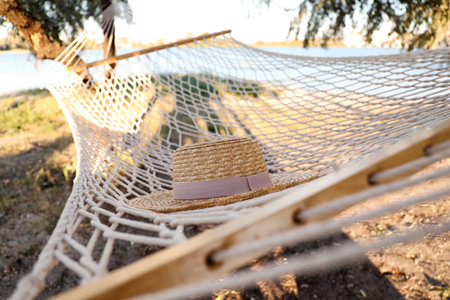 Hat in comfortable hammock on the beach, closeup. summer holidaysの写真素材