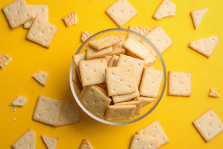 Delicious crackers on yellow background, flat layの写真素材