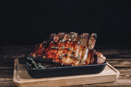 Tasty grilled ribs with thyme on wooden table. food photographyの写真素材