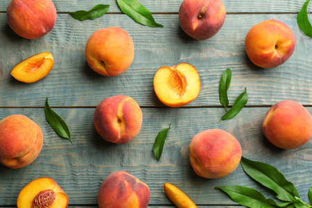 Fresh sweet peaches on wooden table, flat layの写真素材