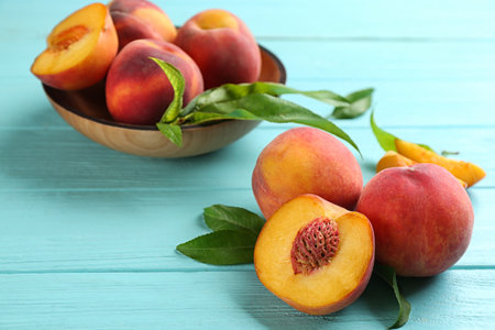 Fresh sweet peaches on turquoise wooden tableの写真素材