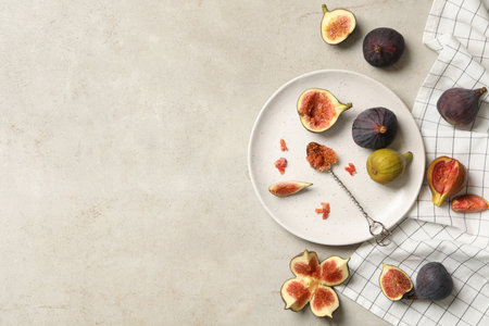 Flat lay composition with delicious figs on light gray table. Space for textの写真素材
