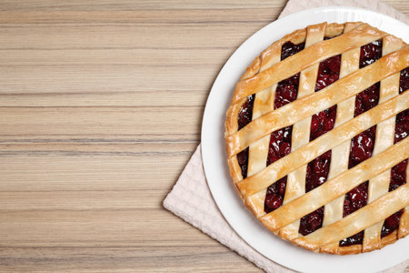 Delicious fresh cherry pie on wooden table, top view. Space for textの写真素材