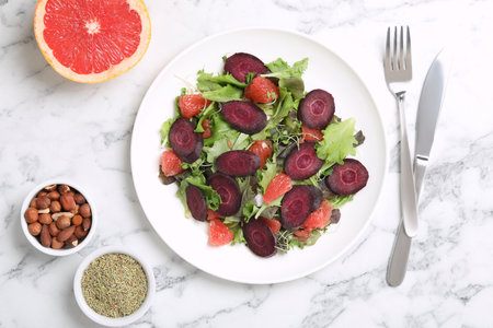 Delicious carrot salad served on white marble table, flat layの写真素材