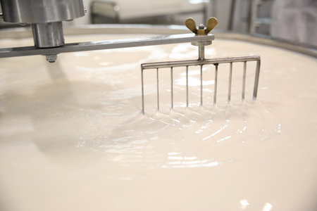 Milk in curd preparation tank at cheese factory, closeupの写真素材