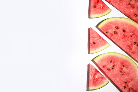 Slices of ripe watermelon on white background, flat lay. Space for textの写真素材