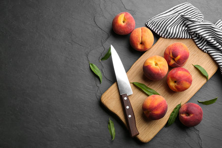 Fresh sweet peaches on black table, flat lay. Space for textの写真素材