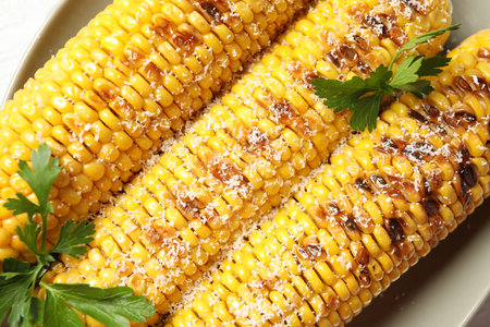 Top view of tasty grilled corn, closeup