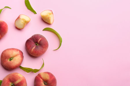Fresh donut peaches on light pink background, flat lay. Space for textの写真素材